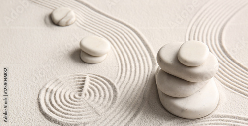 Photography Stones on light sand with lines on Japanese rock garden