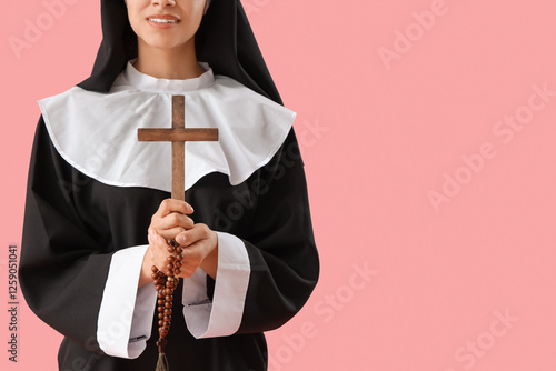 Young nun with cross and be...