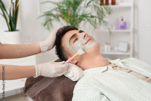 Beautician applying clay ma...
