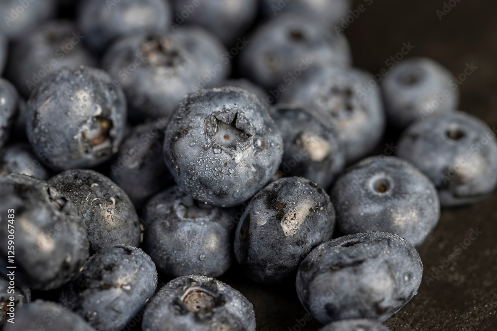 a pile of blueberries scattered on the board a pile of blueberries scattered on the board