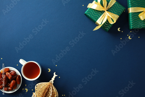 Canvas Print Ramadan Kareem flat lay composition with gift boxes, Arabic lantern, dates, cup of tea on dark blue background