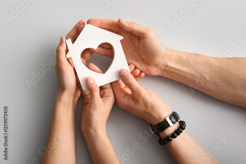 Couple holding house figure...