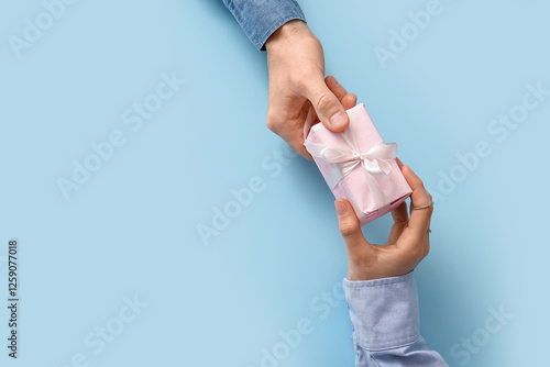Couple holding gift box on ...