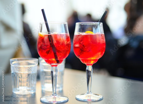 Two glasses of the local aperitivo cocktail Pirlo, a mix of campari, white wine and soda in Brescia, Italy. Selective focus