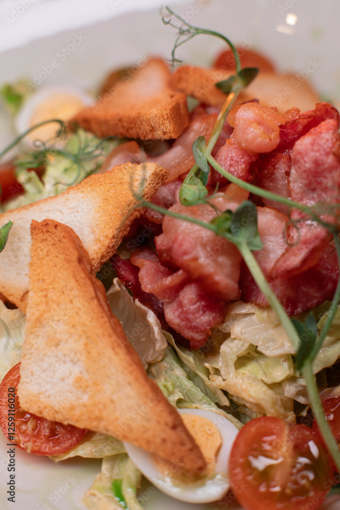 Caesar salad with bacon is mouthwatering and delicious. A beautiful perfect photo for a cafe or restaurant menu, advertisement, culinary website. Suitable for design Caesar salad with bacon is mouthwatering and delicious. A beautiful perfect photo for a cafe or restaurant menu, advertisement, culinary website. Suitable for design