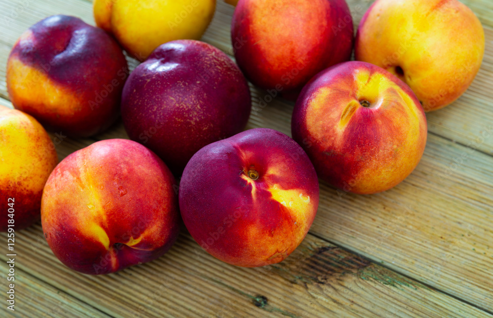 Fresh organic nectarine on wooden background, fruit vegan food Fresh organic nectarine on wooden background, fruit vegan food