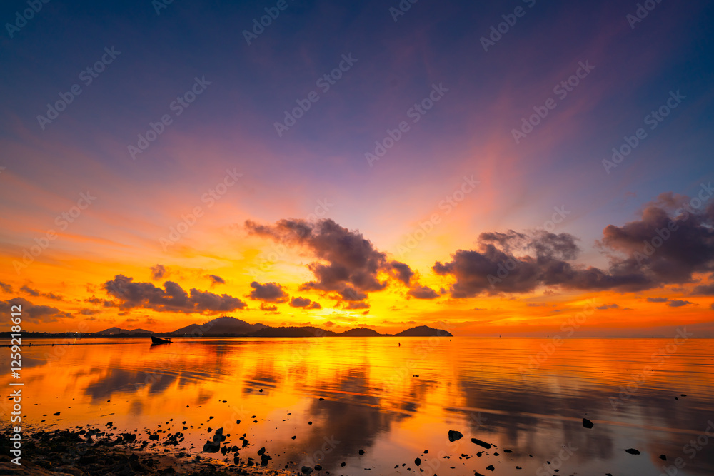 Obraz premium Landscape of colorful clouds in sunset or sunrise sky over sea with reflection in the tropical sea,Beautiful seascape scenery,Amazing light of nature Landscape nature background
