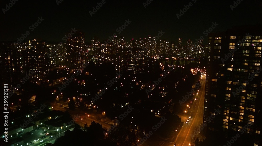 Fototapeta premium Nighttime Cityscape Illuminating Residential Buildings and Streets