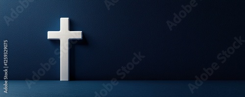 Serene Christian Symbolism Silver Cross Against a Textured Dark Blue Wall Backdrop Design Element photo