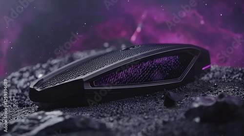 Futuristic gaming device resting on a rocky surface with a cosmic purple background