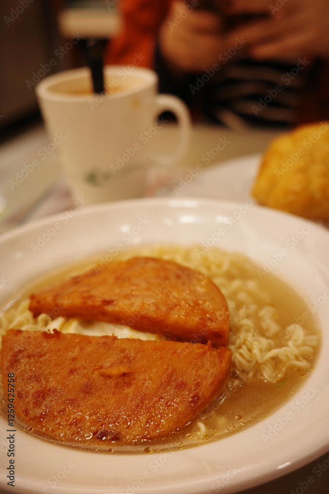 A bowl of luncheon meat instant noodles in a Hong Kong tea restaurant A bowl of luncheon meat instant noodles in a Hong Kong tea restaurant