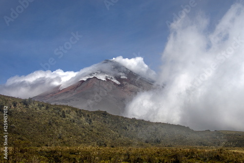 Clouds blowing over Cotopaxi Volcano, which is erupting with a small ash plume, in Cotopaxi National Park, outside of Machachi, Ecuador