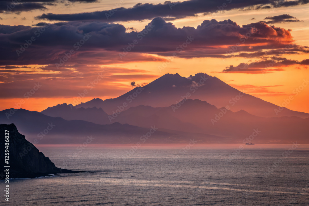 Majestic mountain silhouette at sunset over calm ocean waters Majestic mountain silhouette at sunset over calm ocean waters