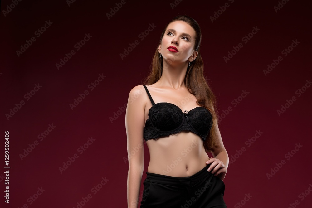 Elegant woman poses confidently in black lingerie against a dark backdrop Elegant woman poses confidently in black lingerie against a dark backdrop