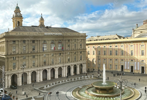 Piazza Ferrari with fountain in Genoa. Buildings and architecture of old town. View from above on sunny winter day in 2025.