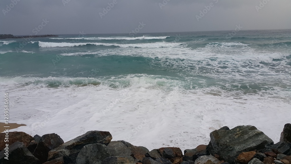 towering waves crashing against rocky shoreline towering waves crashing against rocky shoreline