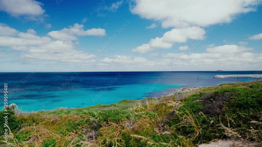Serene blue ocean view with clear blue sky and fluffy clouds. Picturesque ocean coastline, Australia. Summertime at the beach Serene blue ocean view with clear blue sky and fluffy clouds. Picturesque ocean coastline, Australia. Summertime at the beach