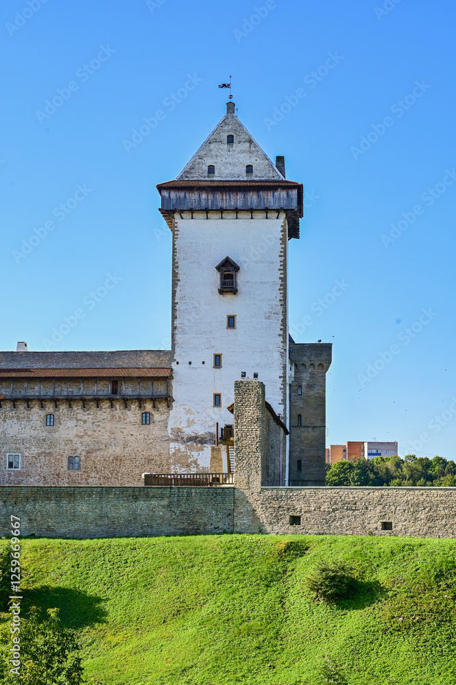 Narva Castle, Hermann's Fortress or ‘Hermanni linnus’ medieval fortress in Narva, Estonia in summer under a blue sky as a historical sight on the Narva River on the border with Russia Narva Castle, Hermann's Fortress or ‘Hermanni linnus’ medieval fortress in Narva, Estonia in summer under a blue sky as a historical sight on the Narva River on the border with Russia