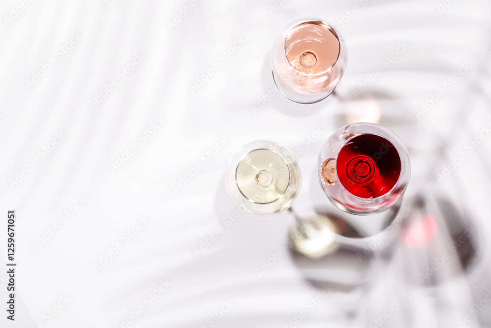 Three wine glasses filled with red, white, and rose wine Three wine glasses filled with red, white, and rose wine