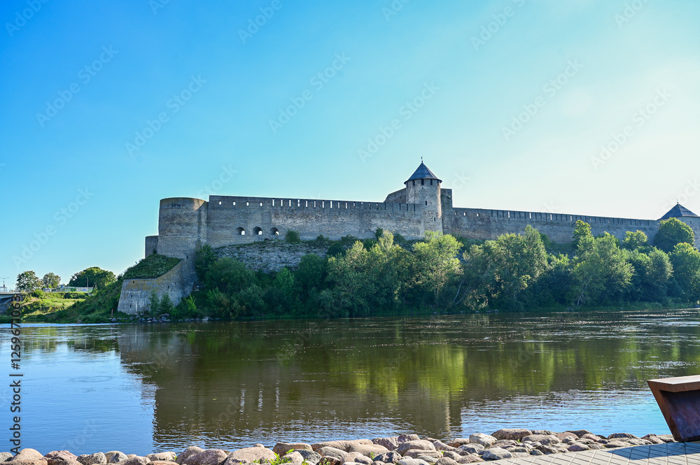 View from Narva in Estonia over the border river Narva and the Russian border to the Ivangorod Fortress in Ivangorod in Russia in summer under a blue sky View from Narva in Estonia over the border river Narva and the Russian border to the Ivangorod Fortress in Ivangorod in Russia in summer under a blue sky