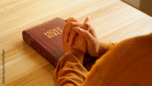 Photography Christian praying and worshiping with both hands clasped on the holy bible