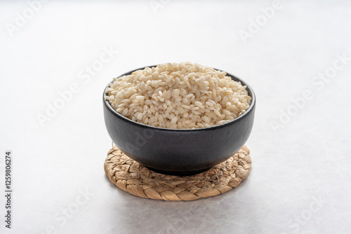 Arborio rice close up on grey background. White short grain rice close up on grey background. 