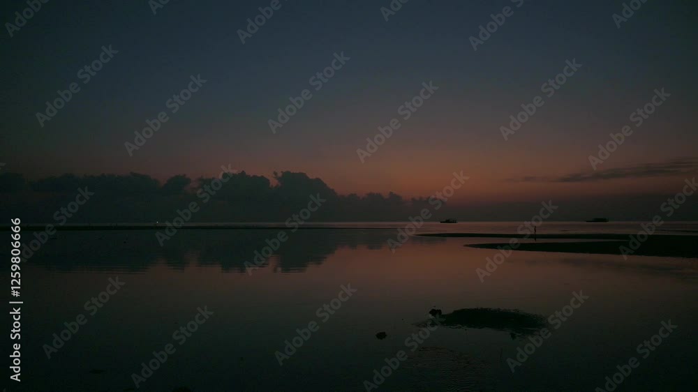 Tranquil scene of the sea in twilight with blue sky and the clouds reflected on surface of water. Beautiful evening seascape background. Tranquil scene of the sea in twilight with blue sky and the clouds reflected on surface of water. Beautiful evening seascape background.