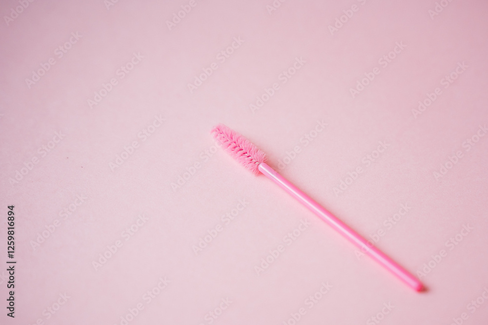 A beautiful and vibrant pink mascara wand stands out against a soft pink background, showcasing the perfect blend of color and style in the world of cosmetics and beauty A beautiful and vibrant pink mascara wand stands out against a soft pink background, showcasing the perfect blend of color and style in the world of cosmetics and beauty