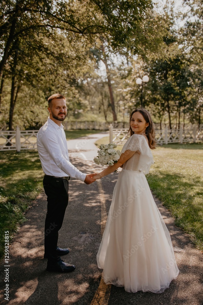 bride and groom walking in park bride and groom walking in park