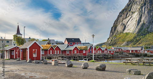 red typical cabins  at the foot of a Norwegian village Reine and rocky mounta...