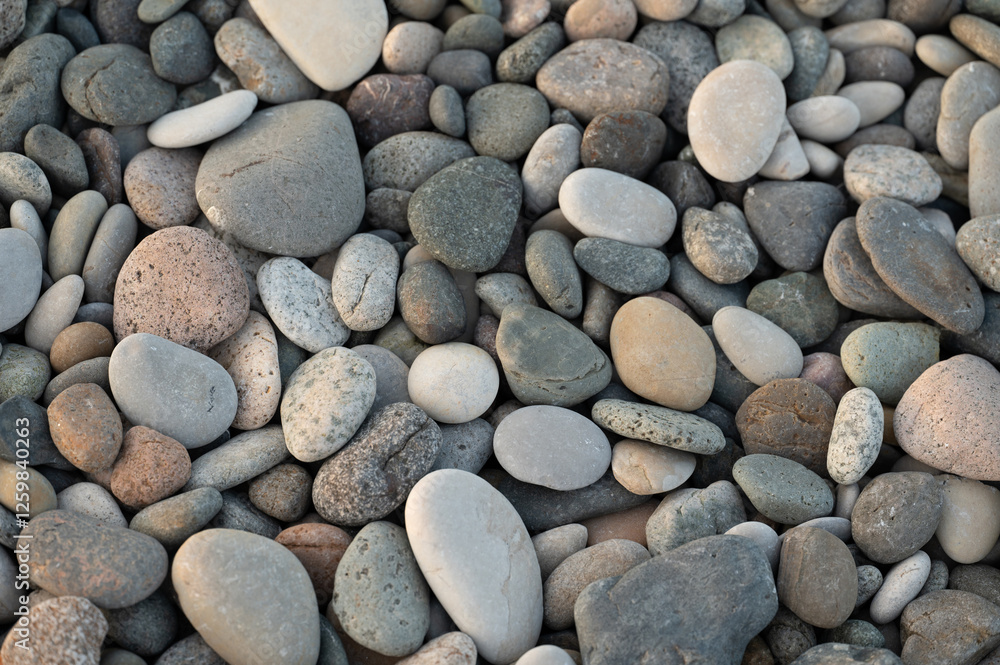 Pebbles of different sizes on pebble beach. Stone texture, background, wallpaper. Beach vacation concept Pebbles of different sizes on pebble beach. Stone texture, background, wallpaper. Beach vacation concept