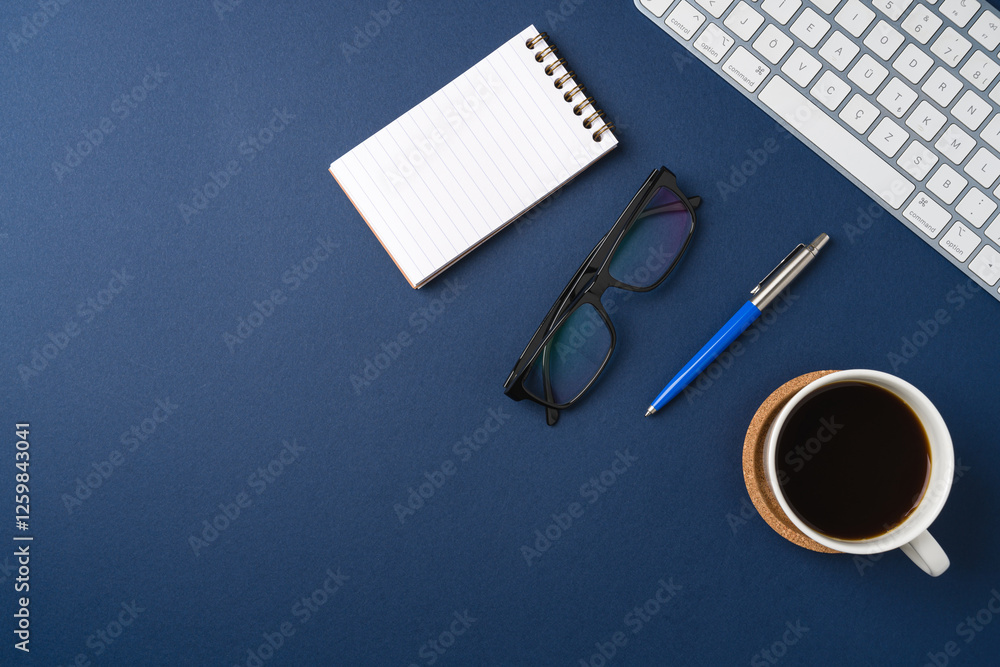 Workspace with keyboard, laptop, office supplies, pen and coffee cup. Flat lay, top view blue office desk Workspace with keyboard, laptop, office supplies, pen and coffee cup. Flat lay, top view blue office desk