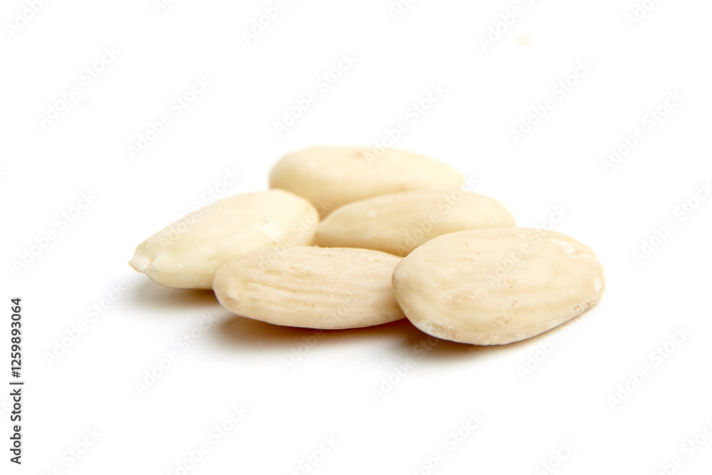 A small pile of raw blanched almonds with smooth, pale skin and natural texture, isolated on a clean white background. Perfect for health and nutrition concepts A small pile of raw blanched almonds with smooth, pale skin and natural texture, isolated on a clean white background. Perfect for health and nutrition concepts