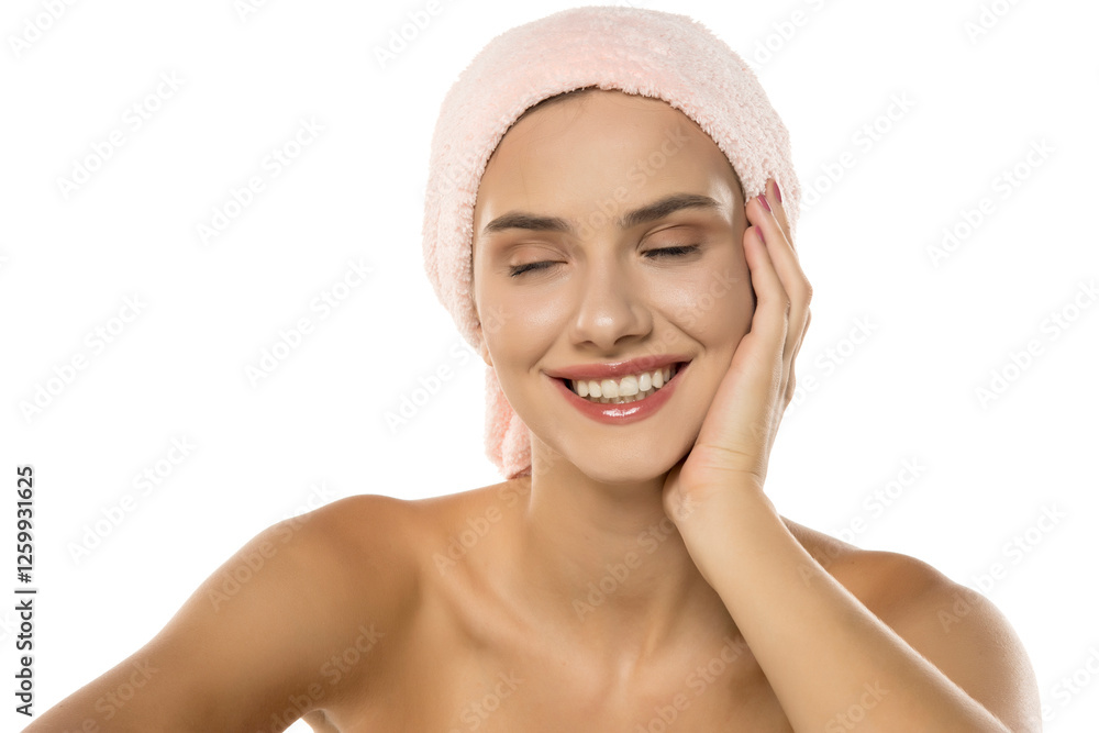 Beautiful young smiling woman with a towel on the head, posing on the white. Skin, cosmetology Beautiful young smiling woman with a towel on the head, posing on the white. Skin, cosmetology