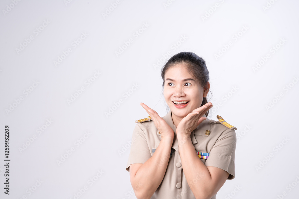 Cheerful Thai teacher in government official school uniform surprise smiling and posing on a white background. Cheerful Thai teacher in government official school uniform surprise smiling and posing on a white background.