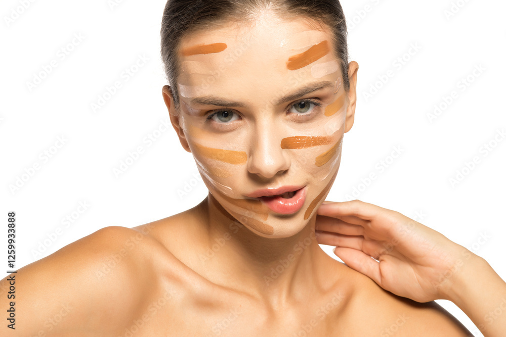 Beautiful young sensual woman posing with different tones of liquid foundation on face Beautiful young sensual woman posing with different tones of liquid foundation on face