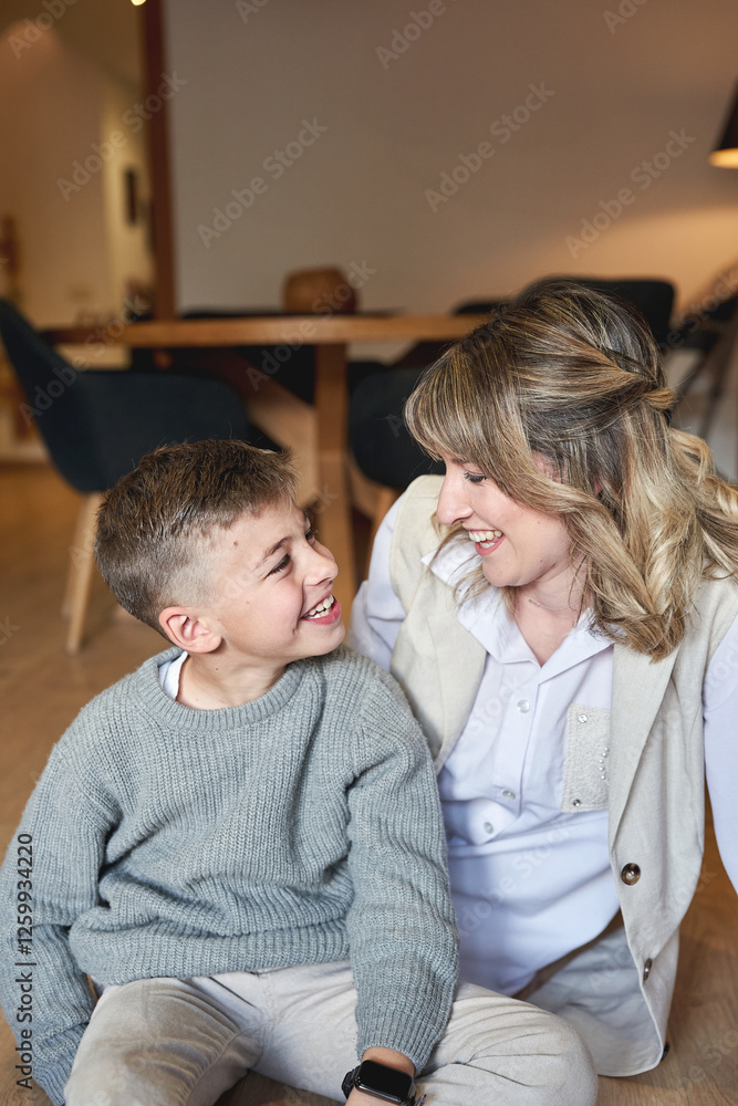 Mother and son sharing a joyful moment and smiling together at home Mother and son sharing a joyful moment and smiling together at home