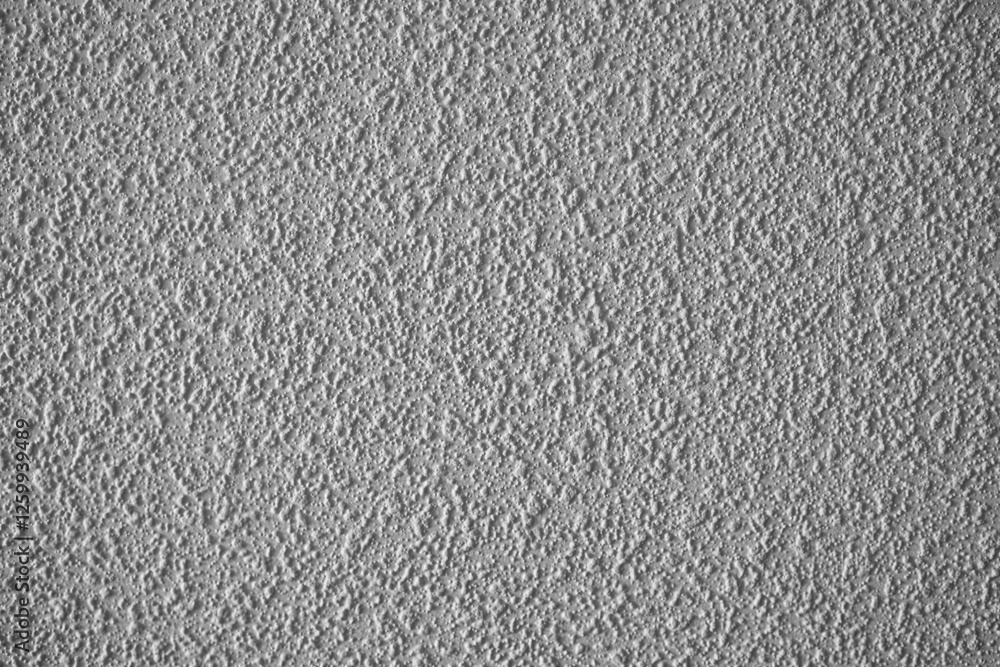 Fototapeta premium Textured wall surface with a subtle gray finish adds depth and character