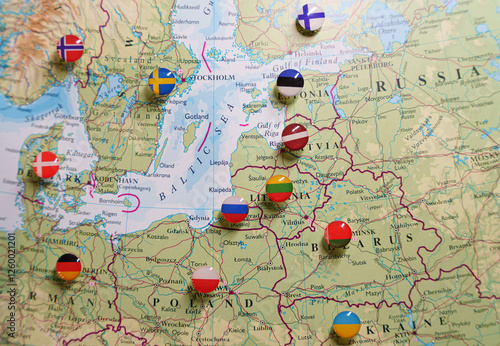 A close-up of a map focused on the Baltic Sea region, Eastern Europe, Scandinavia, with pushpins marking various locations and national flags indicating the countries.