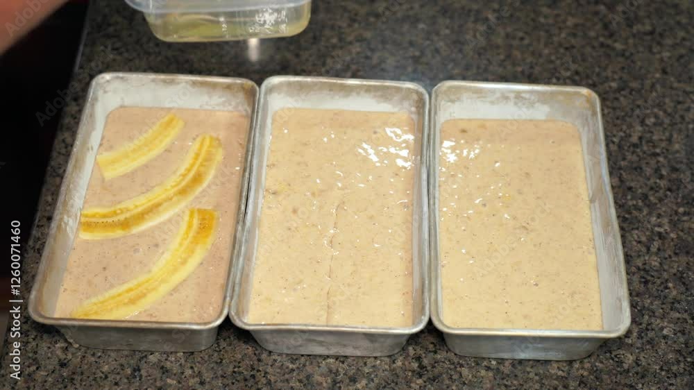Man adding Oil in the centre of banana bread mixture in tin 30 fps.mov Man adding Oil in the centre of banana bread mixture in tin 30 fps.mov