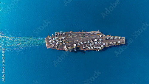 Aerial top view military navy ship carrier at sea.