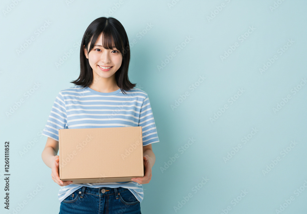 段ボール箱を持つ笑顔の女性、引っ越し、新生活