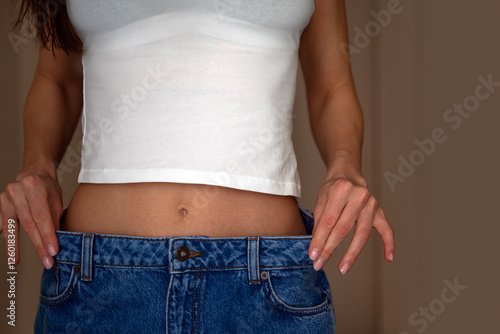 Woman with jeans showing her tight belly  photo