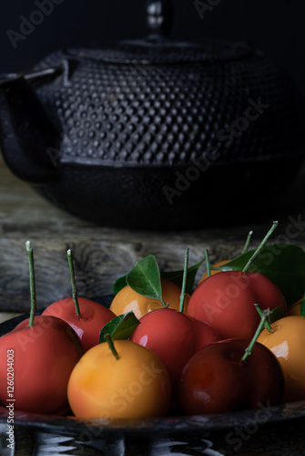 Obraz na płótnie Colorful deletable imitation fruits (Kanom look choup) in the shape of oranges, rose apple and strawberries has a sweet taste. Traditional thai sweet treats made from mung beans and coconut milk. w salonie