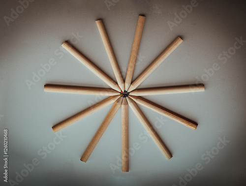 Obraz na płótnie Top view of Brown crayons arranged in a circle on silver background. Wooden colored pencils come together and circle, An artistic display of colored pencils, Stationery for drawing, Minimalism art. w salonie
