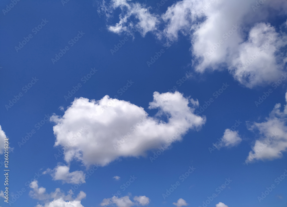 Clear blue sky texture and white fluffy cloud nature background. The sun shines bright in the daytime in summer Clear blue sky texture and white fluffy cloud nature background. The sun shines bright in the daytime in summer