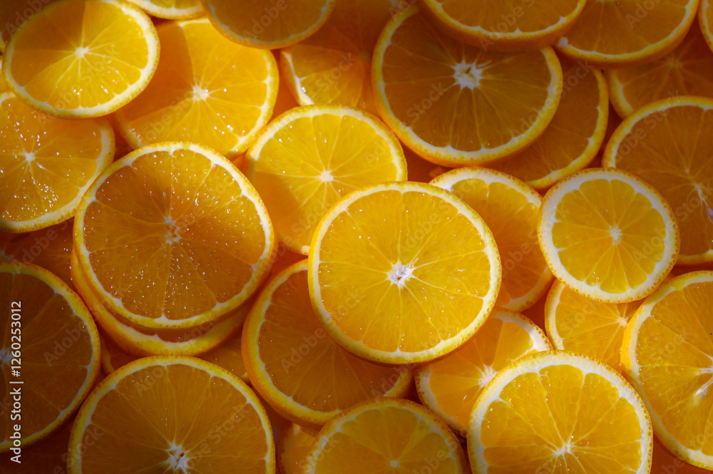 Freshly sliced oranges create a vibrant and sunny display of citrus delight in a rustic kitchen Freshly sliced oranges create a vibrant and sunny display of citrus delight in a rustic kitchen
