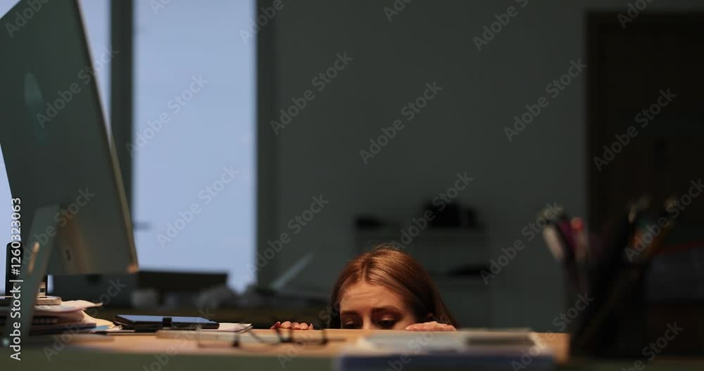 Frightened businesswoman hides in dimly lit office at thunderstorm. Terrified woman office worker takes deep breath and tries to remain unseen. Slow motion Frightened businesswoman hides in dimly lit office at thunderstorm. Terrified woman office worker takes deep breath and tries to remain unseen. Slow motion