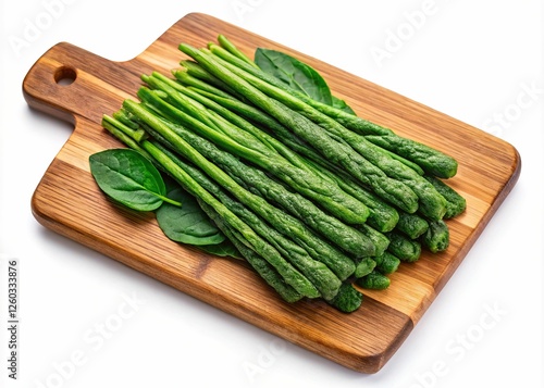 Fresh Asparagus and Spinach Leaves on Cutting Board isolated on white background-A bundle of fresh asparagus spears and spinach leaves neatly arranged on a wooden cutting board, ready for cooking. photo