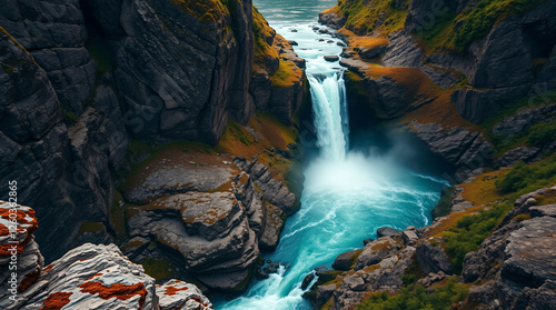 Awe-Inspiring Waterfall and River Set Against Rugged Mountain Terrain